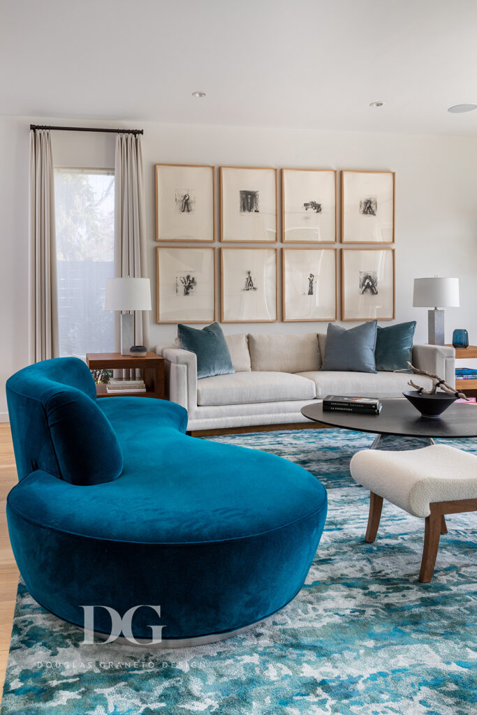 A curved blue Kagan sofa in a modern living room